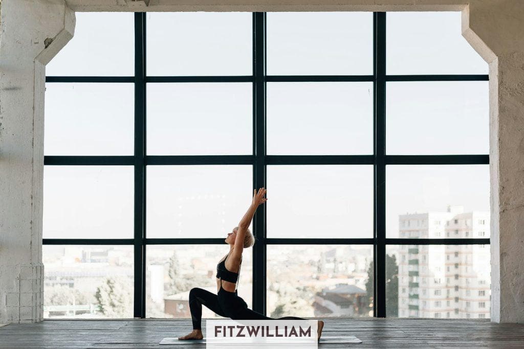 woman in black tank top and black leggings doing yoga
